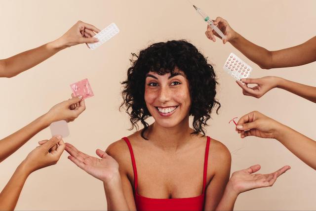 A woman surrounded by many different birth control methods to represent a guide to birth control